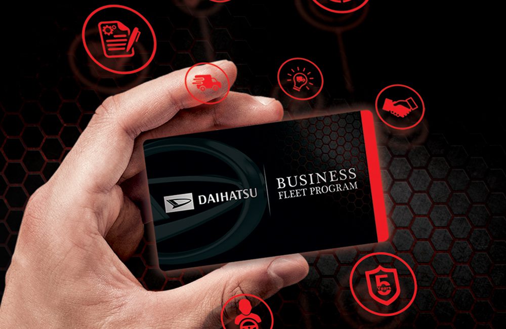 A hand holding a Daihatsu Business Fleet program loyalty card in black background