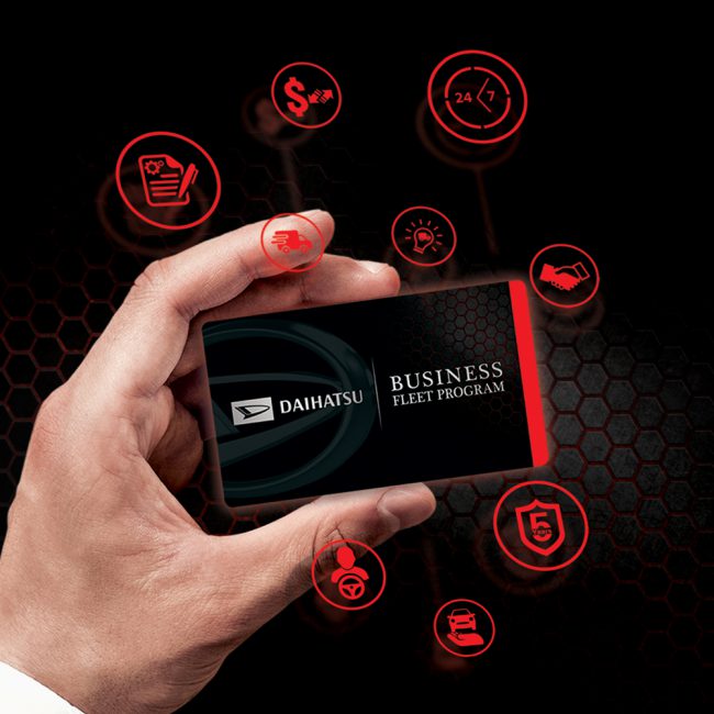 A hand holding a Daihatsu Business Fleet program loyalty card in black background